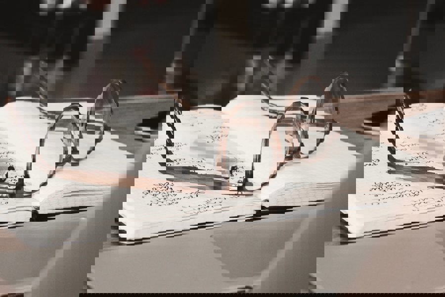 Glasses and pen placed onto of a open notebook. 