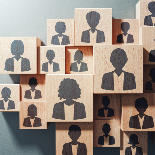 Icon outlines of people on woodblocks stacked together. 