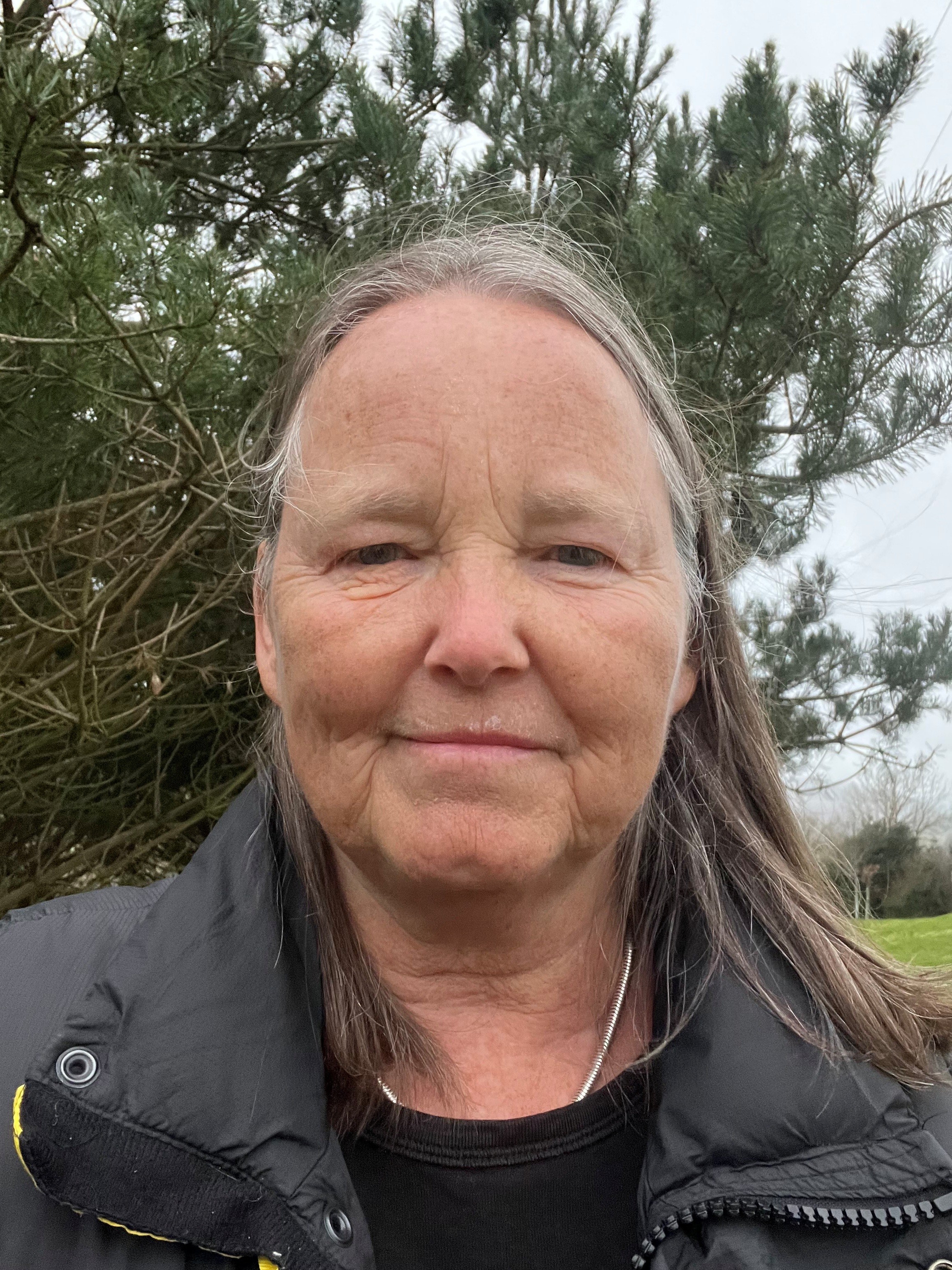 Headshot image of Sally Openshaw standing outside infront of a tree